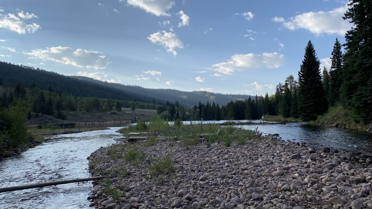 A river running through a forested mountain valley